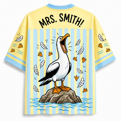 Shirt with a cartoon pelican design and 'MRS. SMITH!' text on a yellow and blue striped background