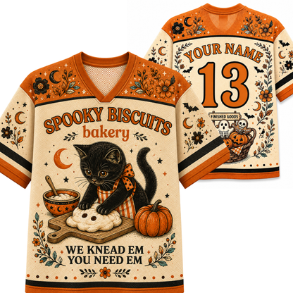A Halloween-themed v-neck t-shirt shown from both front and back. The shirt features a cream base with orange shoulder panels and collar, decorated with illustrations of a black cat kneading a biscuit, pumpkins, bats, and stars.