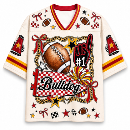An off-white short-sleeve V-neck jersey with red and yellow trim, featuring a large graphic on the front with a football, stars, checkered patterns, the word 'Bulldog', and 'No. 1'.