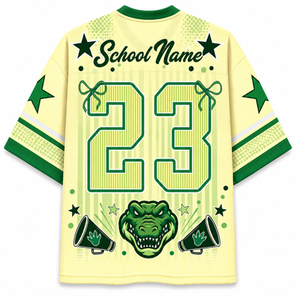 A pale yellow and green custom sports jersey shown from the back, featuring a large number 23, 'School Name' text, green stars, a green alligator head graphic, and green megaphones on a white background.