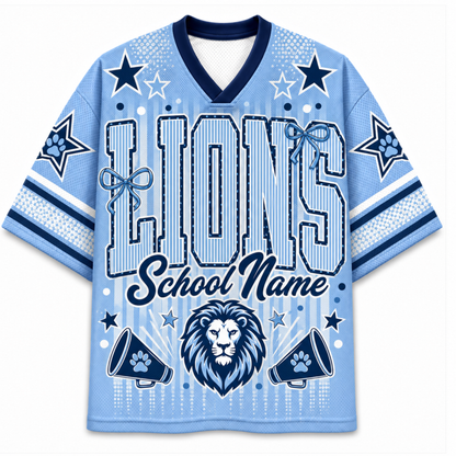A light blue and navy blue custom sports jersey featuring the word 'LIONS' in large outlined letters, 'School Name' in script, a lion graphic, star motifs, paw prints, and bow details on the front and sleeves.