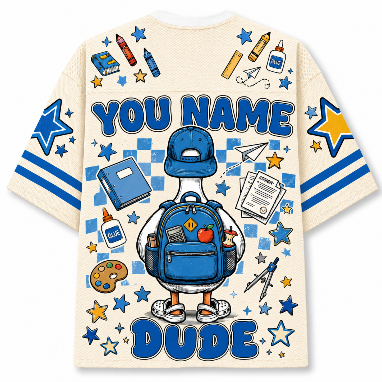 A cream-colored t-shirt with a large blue and yellow graphic print on the back. The design features a cartoon duck wearing a blue baseball cap and backpack, surrounded by school-themed doodles like stars, pencils, and a paint palette.