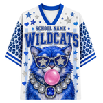 A white and blue short-sleeve V-neck jersey-style shirt with 'SCHOOL NAME WILDCATS' text and a large blue cat graphic wearing star-shaped sunglasses and a jeweled collar, on a plain white background.