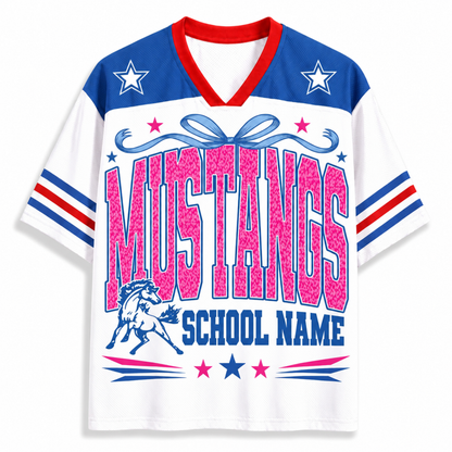 A white short-sleeve V-neck jersey-style shirt with red and blue trim, featuring large pink 'MUSTANGS' lettering, a blue horse graphic, and 'SCHOOL NAME' text on the front.