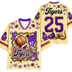 A custom football jersey shown from both the front and back. The jersey is a pale yellow color with purple and gold accents, featuring the word 'Tigers', the number '25', and various football-themed graphics including a football, purple foam finger, stars, and checkered patterns.