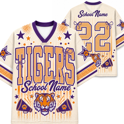 Front and back views of a custom tiger-themed sports jersey on a white background. The jersey features a cream base with purple and orange graphics, including the word 'TIGERS', a tiger head graphic, star and megaphone motifs, and customizable text placeholders 'School Name' and a number '32'.