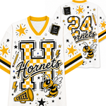 White and yellow varsity-style jersey shown from the front and back, featuring a large checkerboard 'H', the word 'Hornets', the number '24', a hornet bee graphic, stars, lightning bolts, and decorative patches.