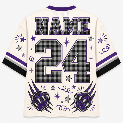 A custom sports jersey shown from the back, featuring a cream-colored body with purple and black plaid graphics. The back displays 'NAME' and the number '24' in a black and gray plaid pattern, framed by purple and black stripes on the sleeves.