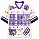 A custom white and purple short-sleeve V-neck jersey with 'WILDCATS' and 'school name' text, a paw print, a wildcat head graphic, stars, stripes, and claw marks on the front.