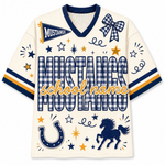 A cream-colored V-neck football jersey with navy blue and gold graphics. The jersey features the word 'MUSTANGS' in a blue-and-white gingham pattern, a blue-and-white gingham bow on the chest, a blue horseshoe, a blue horse silhouette, and a gold script overlay reading 'school name'.