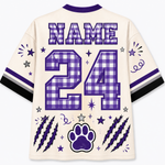 Customizable cream-colored athletic jersey shirt shown from the back, featuring purple and white gingham check patterns on the name and number 24, along with purple paw print, claw marks, and star graphics.
