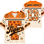 A split screen mockup showing the front and back of the cream and orange Chaotic Club Tiger, Halloween jersey featuring a plaid letter T, bats, pumpkins, and custom back number 13.