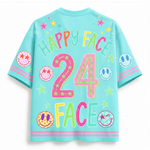 A light blue short-sleeve t-shirt with a colorful retro graphic on the back. The design features the text 'HAPPY FACE 24 FACE' in vibrant neon colors, decorated with smiley faces, stars, and circular patterns.