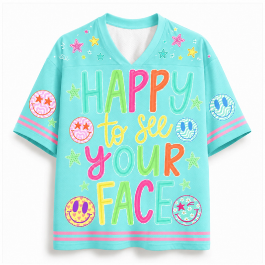 A light blue short-sleeve V-neck t-shirt with a colorful retro graphic that reads 'HAPPY to see YOUR FACE' in multicolored letters, decorated with smiley faces, stars, and stripes.