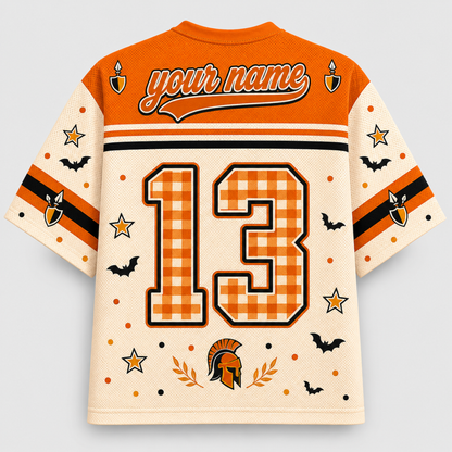 A custom-designed short-sleeve athletic jersey shown from the back, featuring an orange and cream color scheme with a gingham patterned number 13, 'your name' text, and Halloween-themed graphics including bats, stars, owls, and a Spartan helmet.