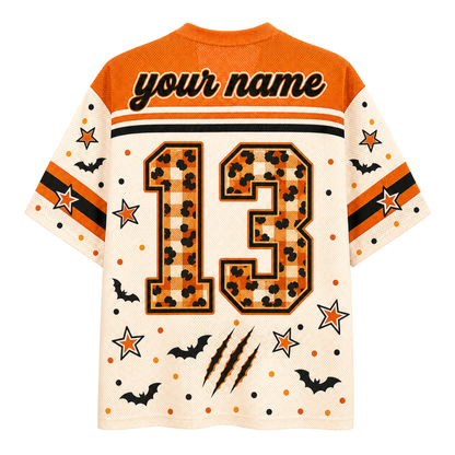 A short-sleeve mesh jersey shown from the back, featuring an orange and cream Halloween theme with 'your name' text, the number 13 in a leopard print pattern, stars, bats, and claw marks.