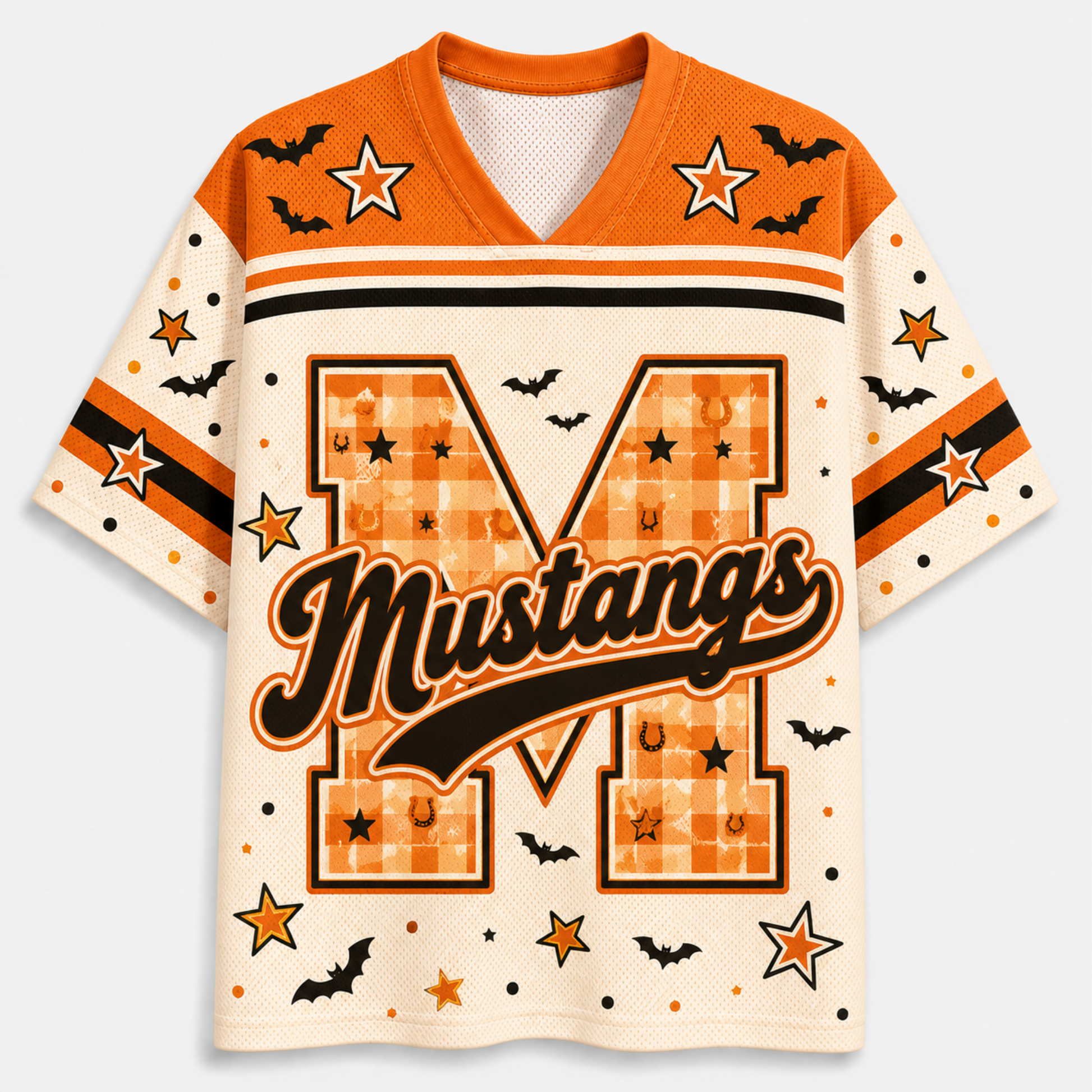 A short-sleeve football-style jersey with a Halloween theme, featuring an orange and cream color palette. The front displays a large letter 'M' with a plaid pattern, the word 'Mustangs' in black script, and various printed motifs including bats, stars, and horseshoes.