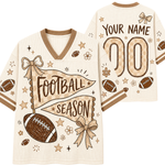 Front and back views of a customizable football-themed mesh jersey in cream and brown. The front features a large pennant graphic reading 'FOOTBALL SEASON' with a football, ribbon, stars, and small flowers.