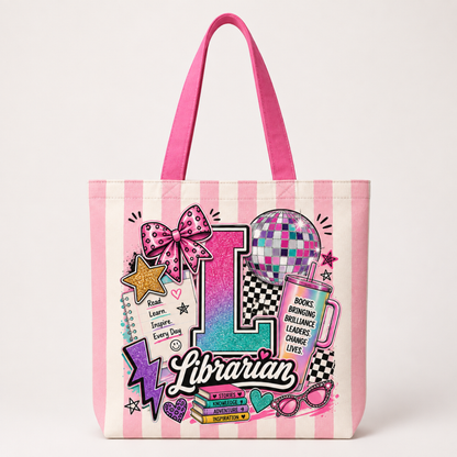 A pink and white striped canvas tote bag with bright pink handles, featuring a colorful 'Librarian' graphic design with a large letter 'L', disco ball, books, and stars.
