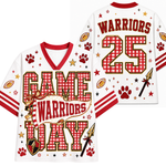 White football-style jersey shown from front and back with red and gold gingham graphics, the word 'WARRIORS' on the back, number 25, and 'GAME WARRIORS' on the front, plus paw prints, stars, footballs, and arrows.