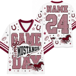 White football-style jersey shown from the front and back with maroon trim, gingham number panels, horseshoes, stars, footballs, and a mustang graphic. The front reads “GAME MUSTANGS DAY,” and the back has a large gingham “NAME 24” with a mustang and stars.
