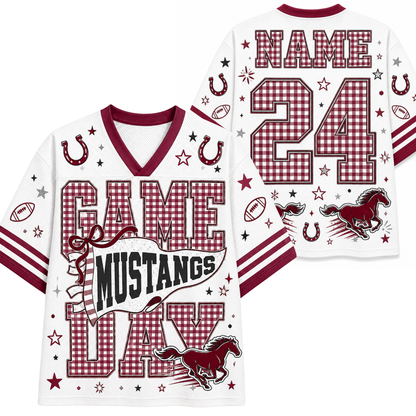 White football-style jersey shown from the front and back with maroon trim, gingham number panels, horseshoes, stars, footballs, and a mustang graphic. The front reads “GAME MUSTANGS DAY,” and the back has a large gingham “NAME 24” with a mustang and stars.