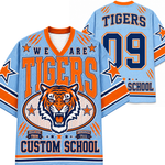 A light blue and orange custom hockey-style jersey shown from both front and back, featuring a tiger graphic, large 'TIGERS' text, '09', and 'SCHOOL' on a white background.