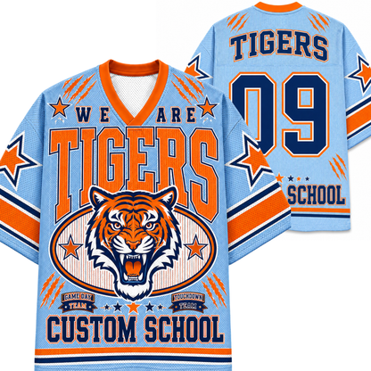 A light blue and orange custom hockey-style jersey shown from both front and back, featuring a tiger graphic, large 'TIGERS' text, '09', and 'SCHOOL' on a white background.