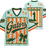 A custom Florida Gators themed jersey shown from the front and back. The light blue base features green and orange accents, including a large 'Gators' script, alligator graphics, stars, stripes, and a bow.