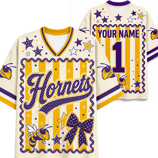 Customizable cream-colored jersey shirt mockup showing both front and back views. Features purple and yellow varsity-style graphics, including 'Horns' script, stars, bumblebees, a large bow motif, and placeholder text 'YOUR NAME' and number '1'.
