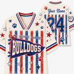 Personalized bulldog-themed sports jersey shown from the front and back on a light gray background. The cream-colored jersey features red and blue distressed vertical stripes, red paw prints, blue paw prints, red stars, blue stars, and a large 'BULLDOGS' banner on the front with 'SCHOOL NAME' and 'Your Name' text placeholders.