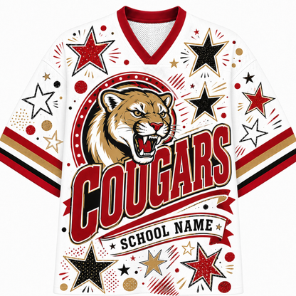 A white custom sports jersey featuring a roaring cougar mascot graphic, the word 'COUGARS' in large red letters, and 'SCHOOL NAME' on a banner. The jersey is decorated with red, black, and gold stars, dots, and stripes on the sleeves and shoulders.
