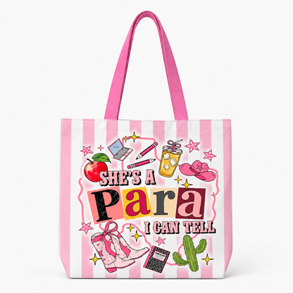 A pink and white striped tote bag with bright pink handles, featuring a colorful graphic print that reads 'She's a Para I Can Tell' surrounded by western and school-themed illustrations.