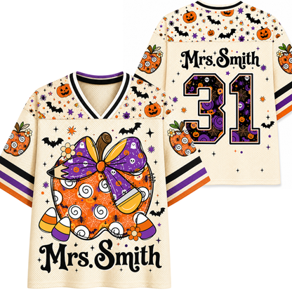 Front and back views of a custom hockey-style jersey with a Halloween theme. The cream-colored mesh jersey features orange pumpkins, black bats, purple bows, candy corn, and the text 'Mrs.