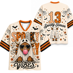 A Halloween-themed short-sleeve V-neck t-shirt shown from both front and back on a plain white background. The shirt has orange and black striped sleeves, a cream base, and a graphic of a cow in a ghost costume with a pink bubblegum mouth.