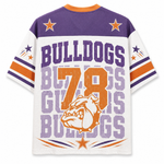 A white short-sleeve athletic-style shirt with purple and orange graphics, shown from the back. The design features 'BULLDOGS' in large purple letters, a large distressed orange '78', a bulldog mascot illustration, and purple and orange stars on the shoulders and sleeves.