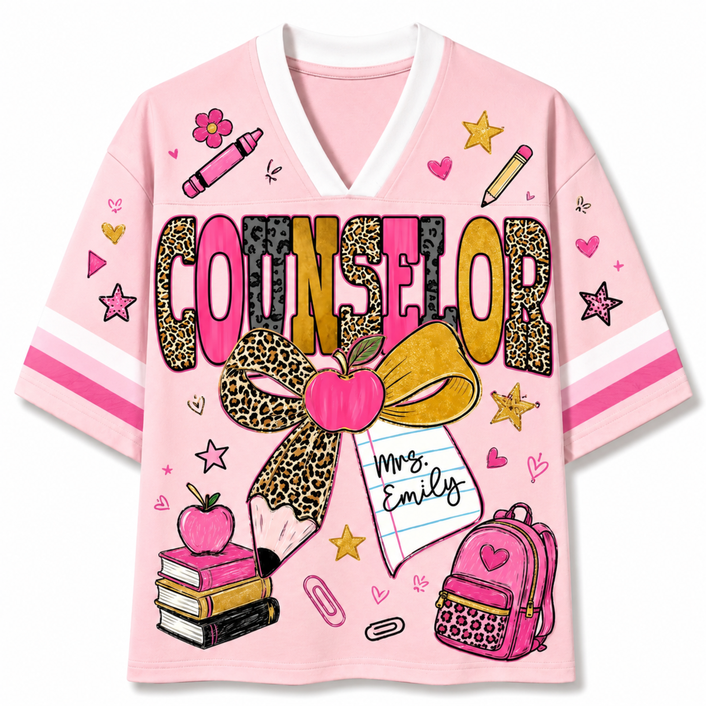 A pink short-sleeve V-neck t-shirt with a white collar, featuring a colorful graphic print on the front. The design includes the word 'COUNSELOR' in leopard-print and pink letters, a large leopard-print bow with a pink apple, a pencil, a notebook that says 'Mrs.