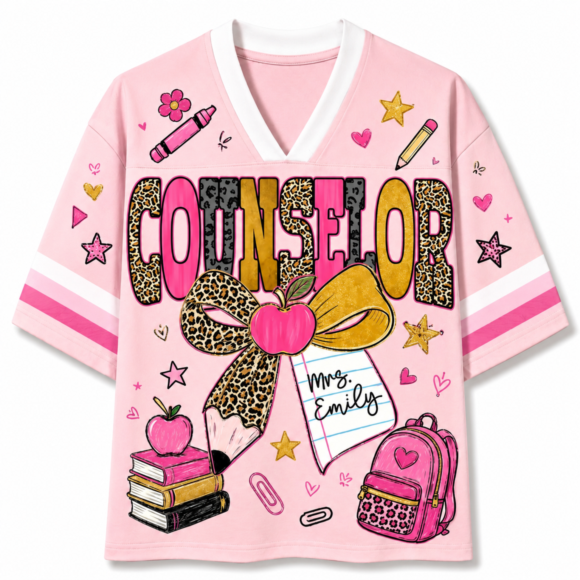 A pink short-sleeve V-neck t-shirt with a white collar, featuring a colorful graphic print on the front. The design includes the word 'COUNSELOR' in leopard-print and pink letters, a large leopard-print bow with a pink apple, a pencil, a notebook that says 'Mrs.