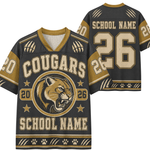 Customizable black and gold sports jersey shown from both front and back, featuring a cougar mascot graphic, paw prints, and placeholder text 'SCHOOL NAME' and number '26'.