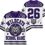 A custom Wildcats sports jersey shown from both front and back views. The jersey is white with purple and black accents, featuring a distressed purple 'WILDCATS' text, a wildcat graphic in a circular emblem, the number '26', and customizable 'SCHOOL NAME' text.