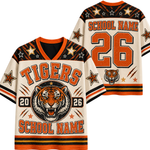 A custom tiger-themed sports jersey shown from both front and back. The jersey has a cream base with orange and black graphics, featuring a roaring tiger graphic, the word 'TIGERS', a large number '26', and placeholder text for school name and number.