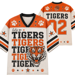 A football-style jersey shown from the front and back on a plain white background. The front has orange shoulder panels, a cream body, black and orange lettering reading 'let's go TIGERS TIGERS TIGERS TIGER,' paw prints, stars, and a tiger head graphic.
