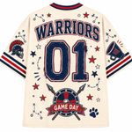 The back of a cream-colored short-sleeve t-shirt featuring a distressed sports graphic design. The design includes 'WARRIORS' in arched navy blue letters with red and blue outlines, the number '01' in large navy blue block letters, a Spartan helmet on the right sleeve, a megaphone with an 'W' on the left sleeve, and a shield with crossed spears and a 'GAME DAY' banner at the bottom.