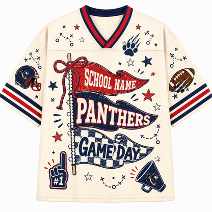 A cream-colored short-sleeve V-neck jersey-style shirt with red and navy trim, featuring a large football-themed graphic print on the front with banners reading 'SCHOOL NAME PANTHERS' and 'GAME DAY,' plus stars, paw prints, a football, helmet, megaphone, and number 1 hand icon.