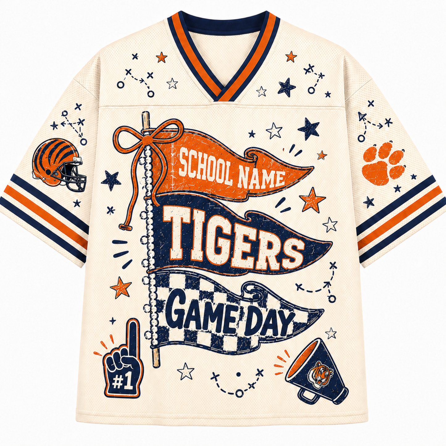 A cream-colored short-sleeve V-neck jersey-style shirt with navy and orange trim, decorated with tiger-themed graphics including a football helmet, paw print, stars, banners reading 'School Name Tigers Game Day,' and a foam finger.