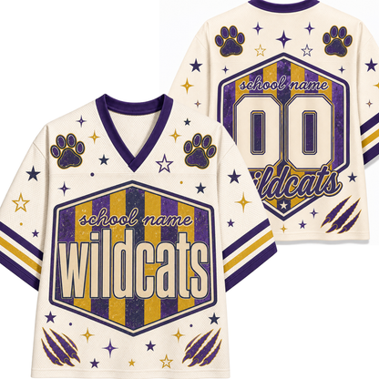 Custom football jersey mockup showing front and back views. The jersey is cream-colored with purple and gold accents, featuring a central shield graphic with 'school name Wildcats' text, paw prints, stars, and claw marks.