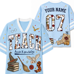 A light blue short-sleeve V-neck T-shirt shown from both front and back, decorated with Harry Potter-themed graphics including the word 'TEACH' in a patterned font, 'YOUR NAME' and '07' on the back, a hat, broom, owl, wand, books, and other magical illustrations.