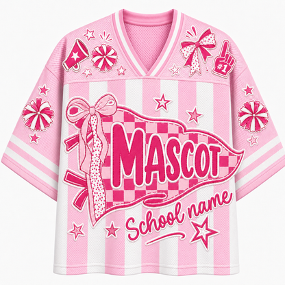 A pink and white striped V-neck athletic-style shirt with a large front graphic reading 'MASCOT' and 'School name,' decorated with bows, stars, candy canes, and foam-ball motifs on a light gray background.