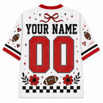 White mesh short-sleeve football jersey shown from the back, featuring customizable black text reading 'YOUR NAME' above large red '00' numbers. The design includes red flowers, black-and-white checkers, red bows, stars, hearts, football motifs, and red/black striped sleeve cuffs on a plain white background.