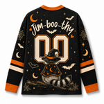 A long-sleeve black Halloween-themed jersey-style shirt shown from the back, with orange and cream graphics including the text 'Jim-boo-thy', large '00' numerals, bats, moons, spiderwebs, stars, and a witch hat and tail illustration.